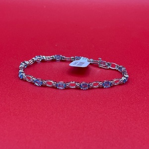  White Gold Tennis Bracelet With Blue Topaz and Heart Accents